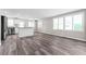 Bright and airy kitchen featuring stainless steel appliances, an island, and wood-look floors, perfect for modern living at 2714 Vindale Rd, Tavares, FL 32778