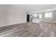 Spacious living room showcases new flooring and leads to an open kitchen area at 2714 Vindale Rd, Tavares, FL 32778