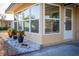 Enclosed sunroom with white framed windows and door, plus decorative rock and planted landscaping at 2714 Vindale Rd, Tavares, FL 32778