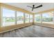 Bright sunroom with large windows offering neighborhood views, and laminate wood floors at 2714 Vindale Rd, Tavares, FL 32778