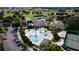 Aerial view features a sparkling pool and outdoor amenities in a vibrant 55+ community at 27536 Stoney Brook Dr, Leesburg, FL 34748