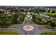 Beautiful aerial shot of the community entrance with lush landscaping and a central American flag display at 27536 Stoney Brook Dr, Leesburg, FL 34748