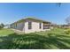 Spacious backyard featuring a well-maintained lawn and covered screened lanai at 27536 Stoney Brook Dr, Leesburg, FL 34748