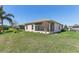 Expansive backyard featuring a well-kept lawn and a view of the screened-in lanai at 27536 Stoney Brook Dr, Leesburg, FL 34748