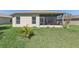 Green backyard with a screened lanai and well-maintained lawn at 27536 Stoney Brook Dr, Leesburg, FL 34748