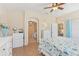 Bedroom with ceiling fan, tile floors, and ensuite bathroom at 27536 Stoney Brook Dr, Leesburg, FL 34748