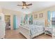 Bright bedroom features a ceiling fan, tile floors, and backyard access at 27536 Stoney Brook Dr, Leesburg, FL 34748