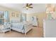 Well-lit bedroom features a ceiling fan, tile floors, and matching furniture at 27536 Stoney Brook Dr, Leesburg, FL 34748