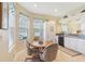 Bright breakfast nook with a table and chairs, next to white kitchen cabinets at 27536 Stoney Brook Dr, Leesburg, FL 34748