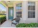 Welcoming front porch featuring a decorative door, bay window, and a cozy seating area at 27536 Stoney Brook Dr, Leesburg, FL 34748