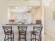 Kitchen bar with seating, open to kitchen and views of the backyard at 27536 Stoney Brook Dr, Leesburg, FL 34748