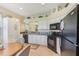 Bright kitchen with white cabinets, dark appliances, and breakfast nook at 27536 Stoney Brook Dr, Leesburg, FL 34748