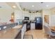 Well-maintained kitchen featuring white cabinetry, tile floors, and dark appliances at 27536 Stoney Brook Dr, Leesburg, FL 34748