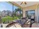 Screened lanai with outdoor furniture and a view of the green backyard at 27536 Stoney Brook Dr, Leesburg, FL 34748