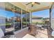 Covered lanai with outdoor seating and a view of the green backyard at 27536 Stoney Brook Dr, Leesburg, FL 34748
