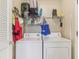 Practical laundry area equipped with washer, dryer, and storage solutions for added convenience at 27536 Stoney Brook Dr, Leesburg, FL 34748