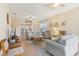 Open living room with tile floors and view to the breakfast bar and kitchen at 27536 Stoney Brook Dr, Leesburg, FL 34748