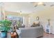Bright living room with tile flooring, ceiling fans, and comfortable seating at 27536 Stoney Brook Dr, Leesburg, FL 34748