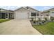Charming single-story home featuring a well-manicured front yard, two-car garage, and inviting curb appeal at 2866 Judah St, The Villages, FL 32163