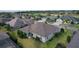 Aerial view of home showcasing manicured lawn, mature landscaping, and a nearby golf course at 2935 Cedar Grove Loop, The Villages, FL 32163