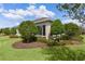Well-maintained backyard featuring lush lawn, mature landscaping, and a cozy sunroom at 2935 Cedar Grove Loop, The Villages, FL 32163
