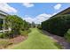 Lush backyard with mature landscaping, a manicured lawn, and privacy hedges at 2935 Cedar Grove Loop, The Villages, FL 32163