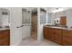 Bathroom view showcasing a glass block shower, vanity with granite countertops, and tile flooring at 2935 Cedar Grove Loop, The Villages, FL 32163