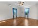 Bright bedroom with hardwood floors, ceiling fan, and sunlit windows at 2935 Cedar Grove Loop, The Villages, FL 32163