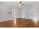Spacious bedroom featuring hardwood floors, white trim, and closet access at 2935 Cedar Grove Loop, The Villages, FL 32163