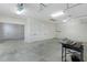 Spacious three-car garage with bright lighting and white doors at 2935 Cedar Grove Loop, The Villages, FL 32163