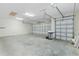 Spacious three-car garage with ample room for parking and storage with multiple overhead doors at 2935 Cedar Grove Loop, The Villages, FL 32163