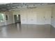 Spacious garage with ample storage, bright lighting, and clean epoxy flooring at 2935 Cedar Grove Loop, The Villages, FL 32163