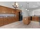 Well-appointed kitchen with central island, ample cabinetry, and modern black appliances at 2935 Cedar Grove Loop, The Villages, FL 32163