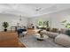 Spacious living room with dining area, filled with natural light and modern furnishings at 2935 Cedar Grove Loop, The Villages, FL 32163