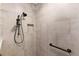 Modern bathroom shower with a handheld shower head, grab bar, and tiled walls with a niche for storage at 2935 Cedar Grove Loop, The Villages, FL 32163