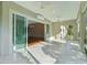 Open sunroom with tile flooring leading to a living area, and outdoor views at 2935 Cedar Grove Loop, The Villages, FL 32163