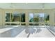 Bright sunroom with tile flooring and panoramic views of the outdoors at 2935 Cedar Grove Loop, The Villages, FL 32163