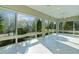 Bright sunroom with tile flooring and panoramic views of the outdoors at 2935 Cedar Grove Loop, The Villages, FL 32163