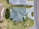 Aerial view of house with landscaped lawn, patio set, driveway, and a neatly manicured yard at 3067 Southern Trce, The Villages, FL 32162