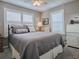 Comfortable bedroom with a plush bed, soft lighting, and window shutters, creating a cozy ambiance at 3067 Southern Trce, The Villages, FL 32162