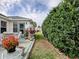 Charming patio overlooking well maintained landscaping and house exterior at 3067 Southern Trce, The Villages, FL 32162