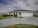 Charming home featuring a well-manicured lawn, lush hedges, and an attached two-car garage at 3067 Southern Trce, The Villages, FL 32162