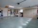 Spacious garage with ample storage cabinets and a door to the house, offering organization and convenience at 3067 Southern Trce, The Villages, FL 32162