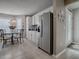 Bright kitchen and dining area featuring stainless steel refrigerator and matching appliances at 3067 Southern Trce, The Villages, FL 32162