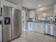 Modern kitchen with stainless steel appliances, white cabinetry, and granite countertops at 3067 Southern Trce, The Villages, FL 32162