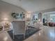 Bright and airy living room featuring a plush sofa, stylish chairs, and a decorative rug at 3067 Southern Trce, The Villages, FL 32162