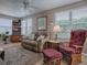 Cozy living room featuring a plush leather recliner and lots of natural light at 3067 Southern Trce, The Villages, FL 32162