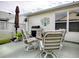 Outdoor patio with seating, grill, and garden decor for relaxing and entertaining in a cozy space at 3067 Southern Trce, The Villages, FL 32162