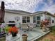 Inviting patio with seating, lush plants, and a grill for enjoyable outdoor living at 3067 Southern Trce, The Villages, FL 32162