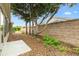 Private backyard features a stone wall, a stone patio and minimal plants at 3233 Belcherry Loop, The Villages, FL 32163